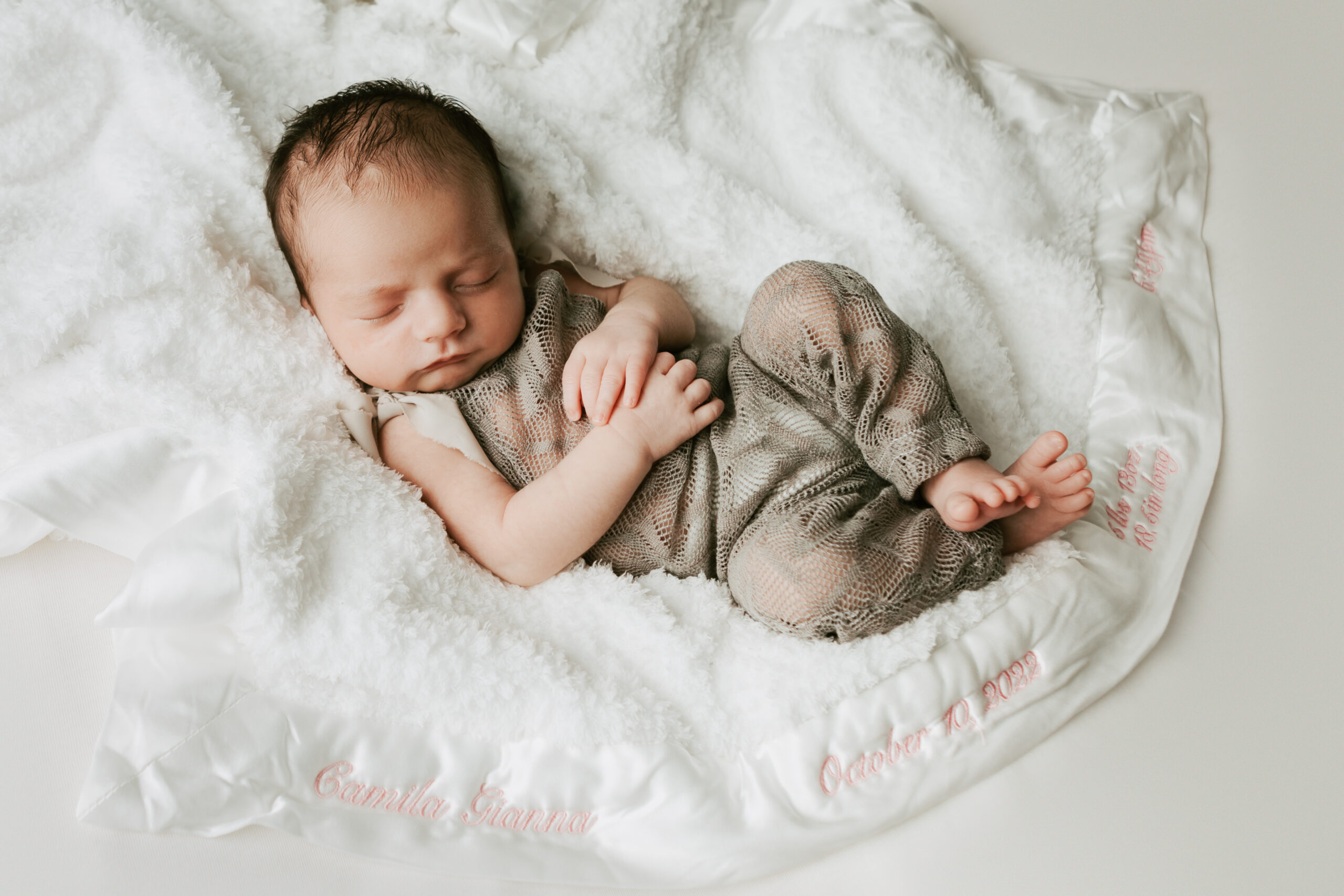 newborn baby sleeping on a blanket