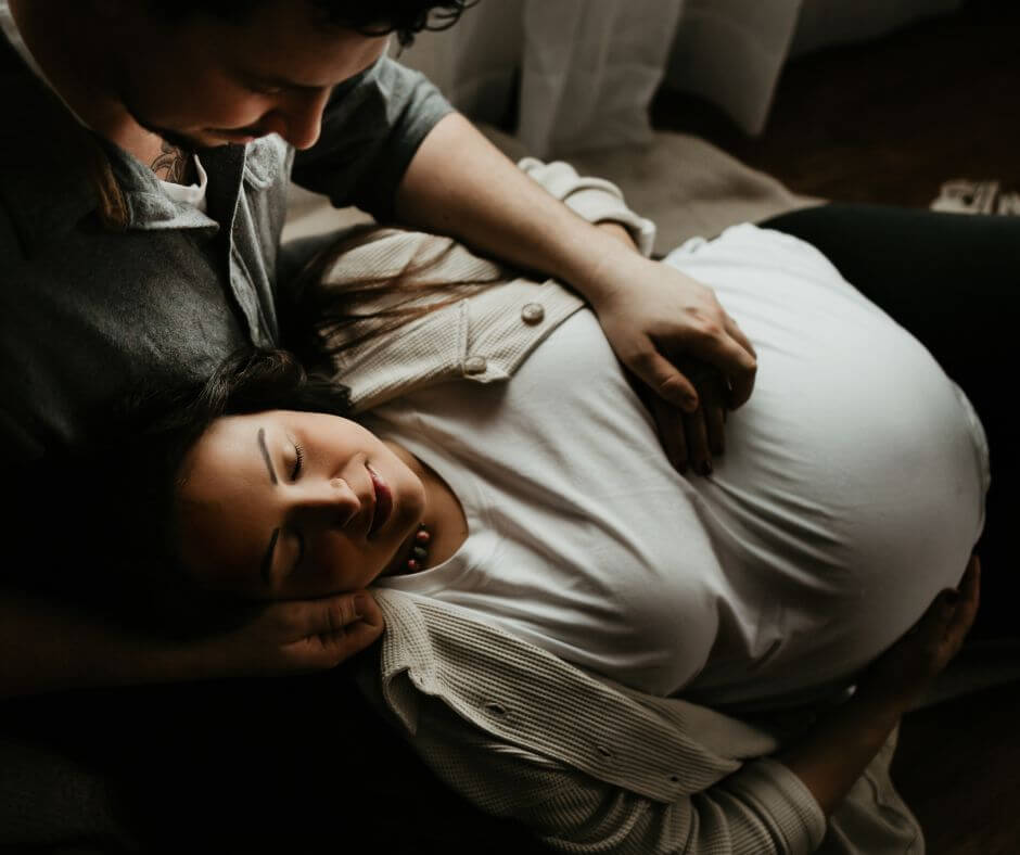 Parents to be relax in their home before their baby's birth after visiting a Pittsburgh prenatal chiropractor