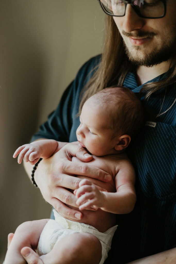 Dad holds his baby during a photo session in Greensburg PA